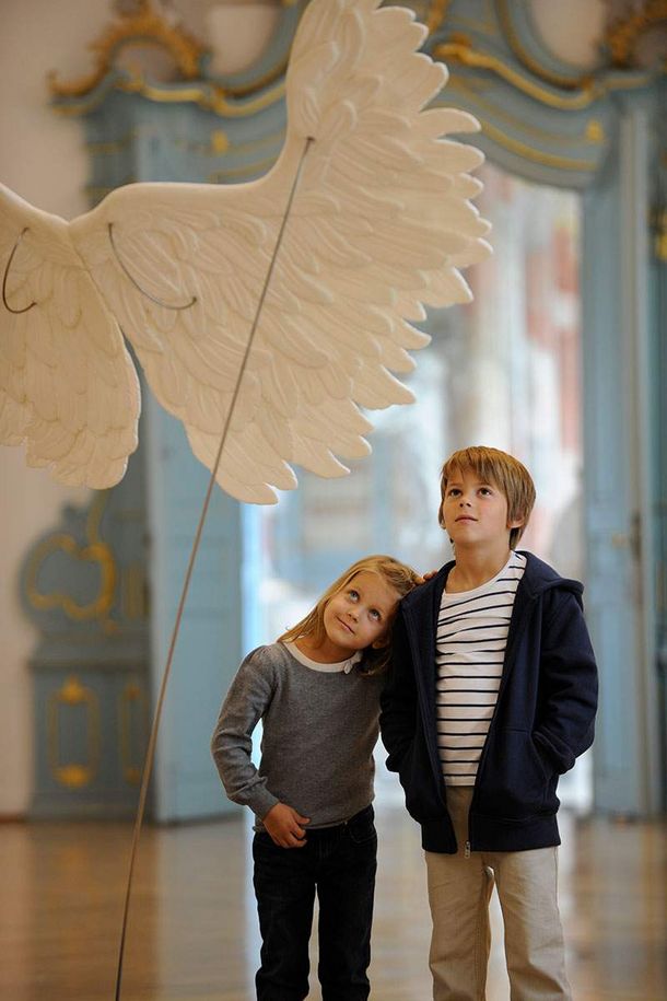 Schussenried monastery, children looking at angels’ wings in the exhibition