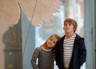 Kinder bestaunen das Flugmodell Pater Mohrs im Bibliothekssaal von Kloster Schussenried